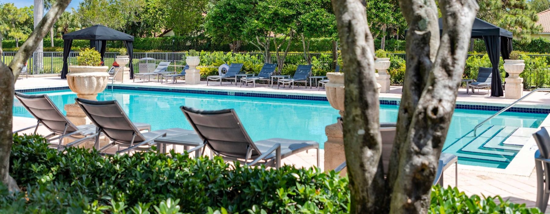 a pool with chairs around it
