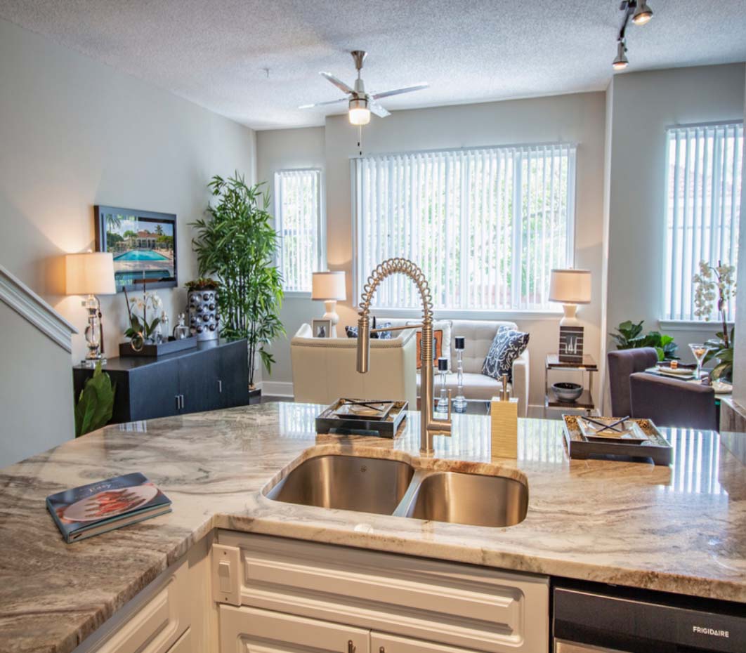 kitchen island and living room at our luxury apartments in Delray Beach