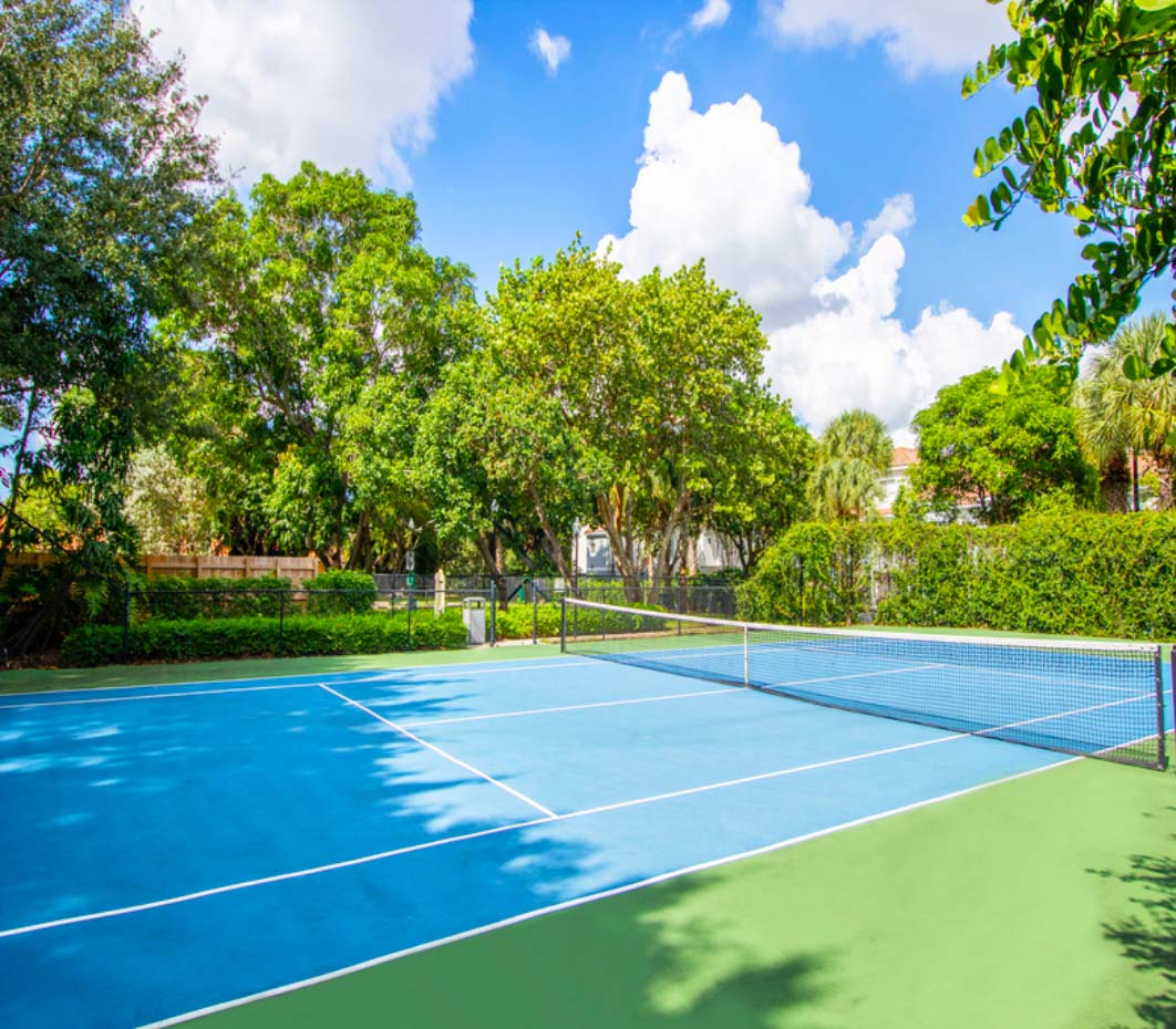 sunlit tennis court at our luxury apartments in Delray Beach